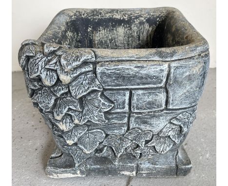 A modern square shaped garden planter modelled as a brick wall with ivy leaf decoration. Approx. 27cm tall x 30cm wide. 