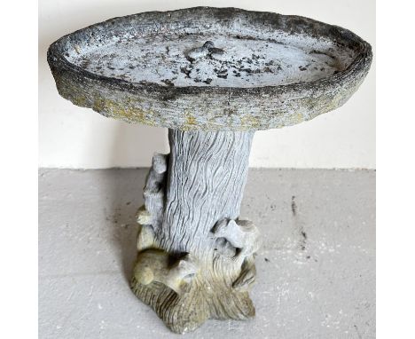 A large modern concrete garden bird bath modelled as squirrels on a tree trunk. With acorn design to oval shaped bath. 2 sect