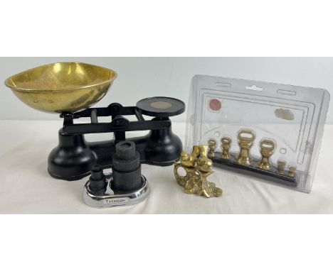 A set of black metal Salter kitchen scales with brass dish and 2 sets of weights - one in plastic case. Together with a small
