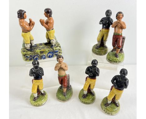 A collection of reproduction Staffordshire style ceramic boxer figurines. Each approx. 19.5cm tall. 