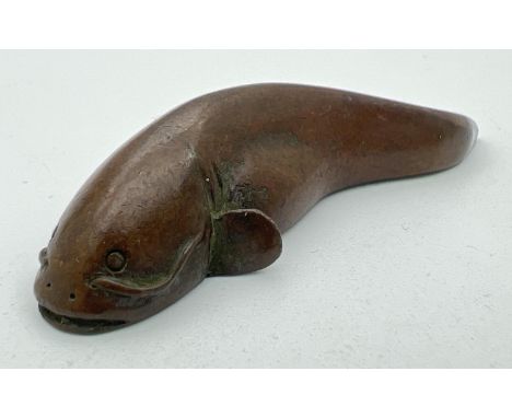 A signed miniature Japanese bronze, modelled as a catfish. Impressed signature to underside. Approx. 6cm long. 