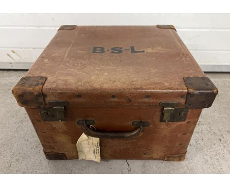 A vintage leather "Osilate" travel trunk with carry handle and brass catches and fixings. Black initials to top of trunk 'B.S