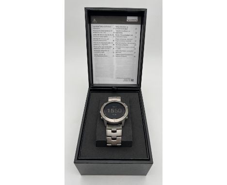 A boxed Garmin Fenix 6X Pro Solar Multisport GPS wristwatch with gunmetal grey titanium strap. With charging lead, extra oran