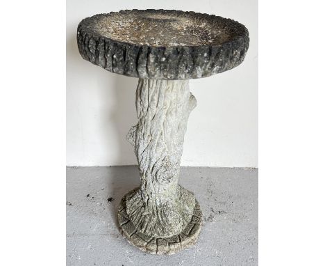 A large vintage weathered concrete bird bath in the form of a tree trunk with shallow bath. 2 sectional. Approx. 69cm tall x 