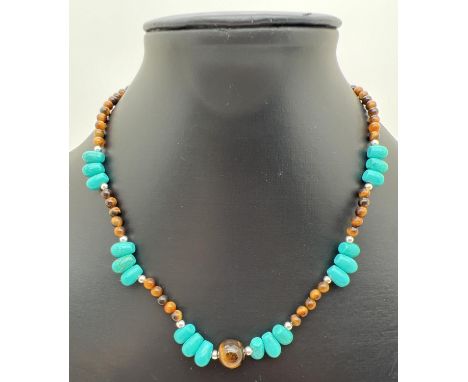 A 16" necklace of Chinese turquoise and tigers eye beads with silver tone spacer beads and S shaped clasp. Retired jewellery 