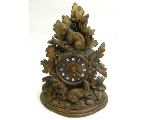 A SWISS CARVED LIMEWOOD MANTLE CLOCK, THE CASE WITH FOXES, OAK LEAVES AND ACORNS, ENAMEL CHAPTER PLAQUES AND FRENCH MOVEMENT,