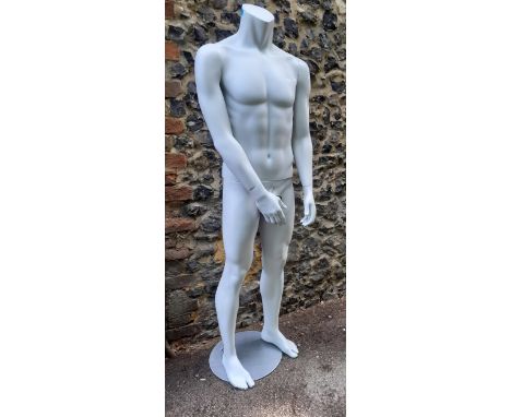 A male shop mannequin with moveable arms on a circular base in a matt silver colour, HEIGHT 171cm. Location:BWR 