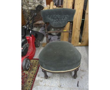 Victorian mahogany upholstered nursing chair, overstuffed seat, and button back with carved decoration below, on turned front