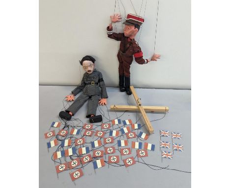 Props from the 1992 film Shining Through, a pair of Pelham puppets of Adolf Hitler and one other, along with miniature flags,