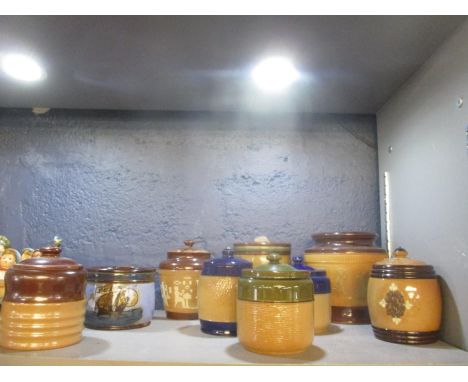 A collection of Doulton stoneware tobacco jars to include one decorated with a sailing vessel and two sprig decoration in the