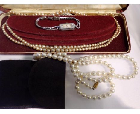 Three strand graduated synthetic pearl necklace boxed and one other single strand necklace and a ladies Bulova cocktail watch