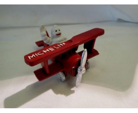 Cast iron Michelin Man in a plane, H: 80 mm. UK P&amp;P Group 1 (£16+VAT for the first lot and £2+VAT for subsequent lots) 