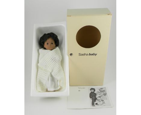 Sasha Baby, circa 1970, with brown hair, brown painted eyes and features, wearing white lawn nightdress, nappy and knitted sh
