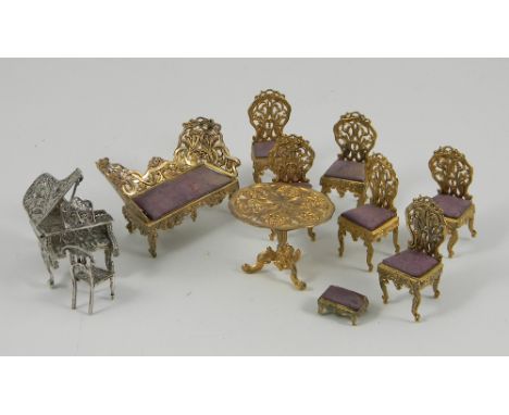 Set of gilt metal furniture, circa 1880, including circular table, sofa, six chairs and foot-stall, all with purple upholster