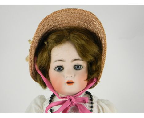 Kammer & Reinhardt bisque head girl doll, German circa 1910, the pale bisque head with weighted blue glass eyes, feathered ey