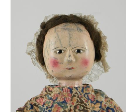 Early English George II painted wooden doll, English circa 1760, the  gesso covered head with carved nose and black glass pup