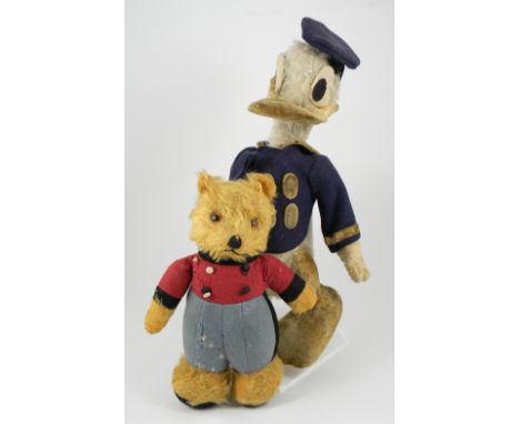Three Teddy bears and a Deans Rag book Donald Duck, including dressed Chiltern with golden mohair, glass eyes, with sewn on r
