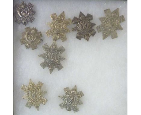 8 Highland Light Infantry cap badges inc Glasgow Highlanders, 9th Battalion H.L.I mounted in glazed display case