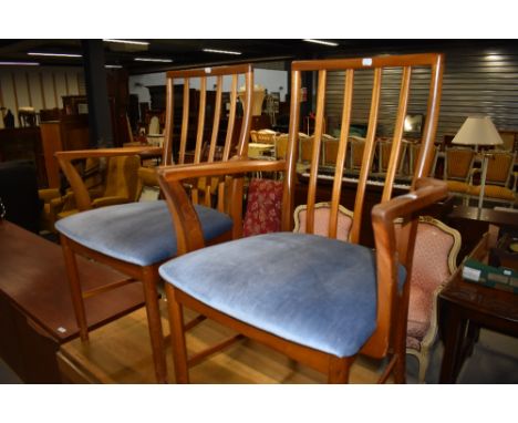 A pair of vintage teak frame railback carver chairs