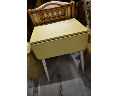 A vintage formica topped drop leaf kitchen table