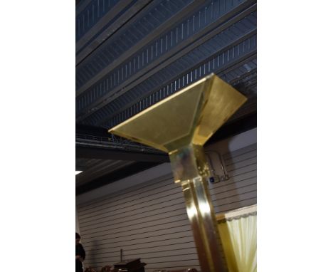 A vintage brass uplighter standard lamp in a Deco style