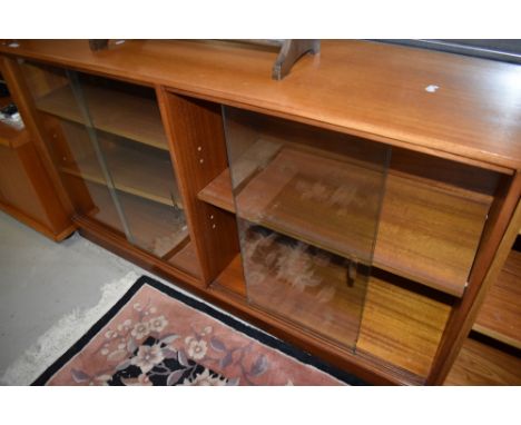 A vintage teak or sapele glazed double bookcase