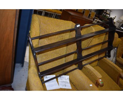 An Ercol dark stained wall shelf