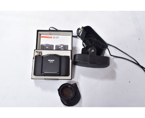 A MINOX 35GT FILM CAMERA in case with a leather pouch