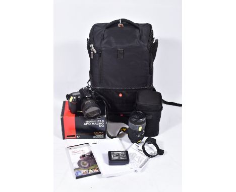 A MANFROTTO CAMERA RUCK SACK CONTAINING A NIKON D90 DIGITAL SLR CAMERA with charger,  cable and one battery, a Nikkor AF-S ED