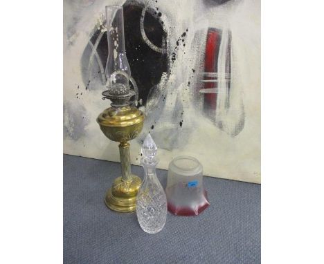 A Victorian brass oil lamp with rose tinted glass shade 