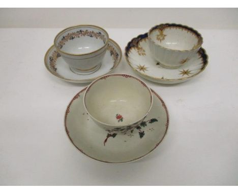 Three 18th century English tea bowls and saucers, two Worcester examples, one decorated with stars and butterflies in blue an