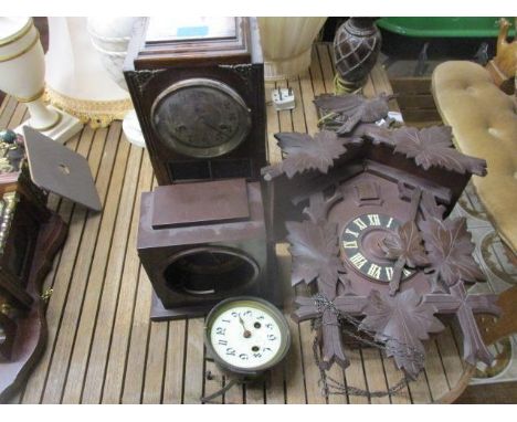 Three clocks to include a cuckoo clock, a Bakelite cased example and a 1930s oak cased mantel clock, along with a clock movem