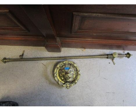A large brass door knocker fashioned as a lion mask, 9 1/2" dia and a Victorian curtain rail 