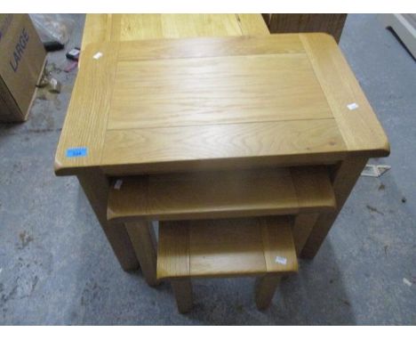 A nesting set of three modern, light oak occasional tables, the largest, 22" h x 25 1/2"w 