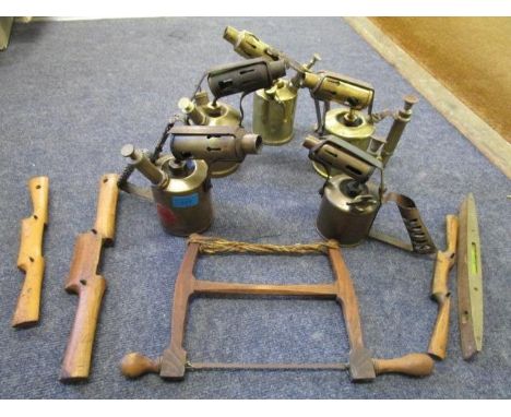 A collection of brass blow torches and a selection of wood carpentry tools 