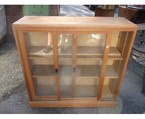 A modern light oak display cabinet having sliding doors on a plinth base, 40" h x 41" w and a two drawer filing cabinet, 26" 