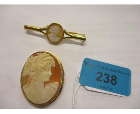 An 18ct gold camera brooch, together with a yellow metal bar brooch 