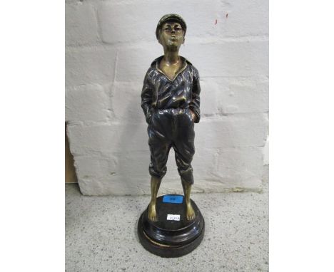 A lacquered bronze figurine of a young man whistling, mounted on a circular base, 14" h 