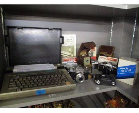 A mixed lot to include a Canon Typestxt 90, an Agfa Super Silette with instruction books, a Tuming C8 cine camera and others 