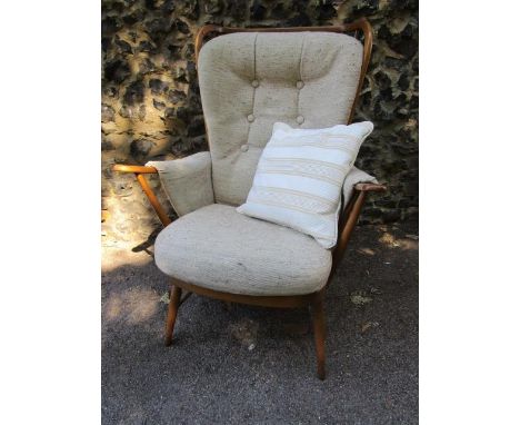 An Ercol Windsor lounge armchair with original upholstered detachable cushions 