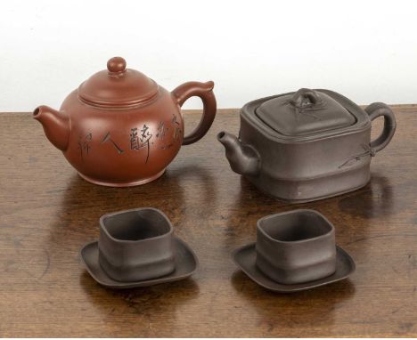 Two Yixing teapots and two tea cups and saucersChinese, 20th Centuryincluding a square teapot and two teabowls and saucers of
