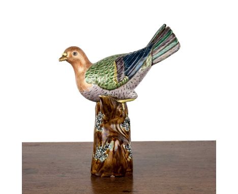 Porcelain model of a birdChinese, 19th Centurythe enamel decorated bird resting on a glazed branch, 27.5cm highProvenance:- W