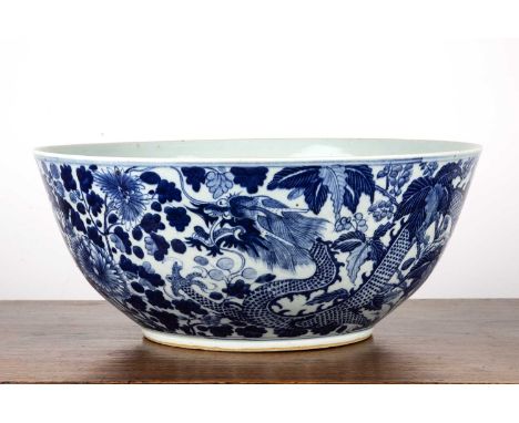 Large blue and white punch bowlChinese, late18th/19th Centurydecorated with two dragons in flight, amongst foliage, the centr