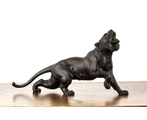 Bronze model of a snarling tigerJapanese, Meiji periodthe animal with its head raised, signed, 34cm long x 18cm highSome slig