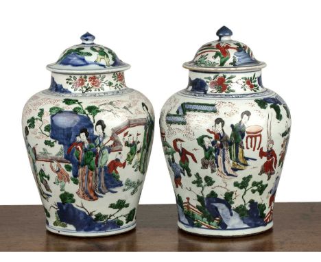 Matched pair of Wucai porcelain vases and coversChinese, Transitional periodeach painted in enamels with long robed ladies, s