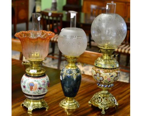 A Brass and Royal Doulton Vase Oil Lamp, relief swags and ribbons, mottled ground, globular glass shade, 44.5cm high; A Brass