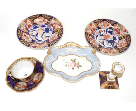 A Worcester Porcelain Coffee Cup and Saucer, circa 1810, painted with kakiemon style flowers in panels on a blue ground gilt 