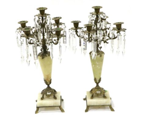 ^ A Pair of Late 19th Century Gilt Metal Mounted Onyx Five-Light Candelabra, the scroll branches hung with glass prismatic dr