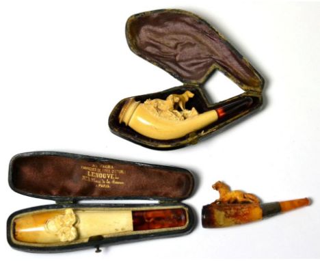 A Meerschaum Cheroot Holder, circa 1910, carved with two hunting dogs, with amber mouthpiece, 9.5cm long, in fitted leather c