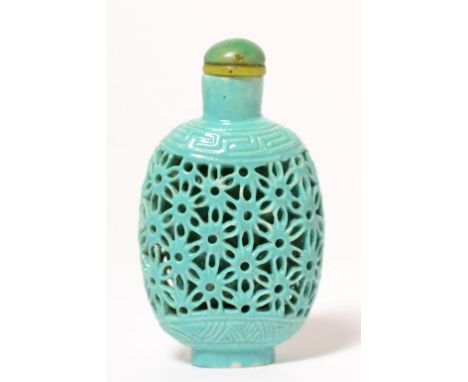 A Chinese Turquoise Glazed Reticulated Snuff Bottle, of flattened ovoid form pierced with interlaced star burst within Greek 